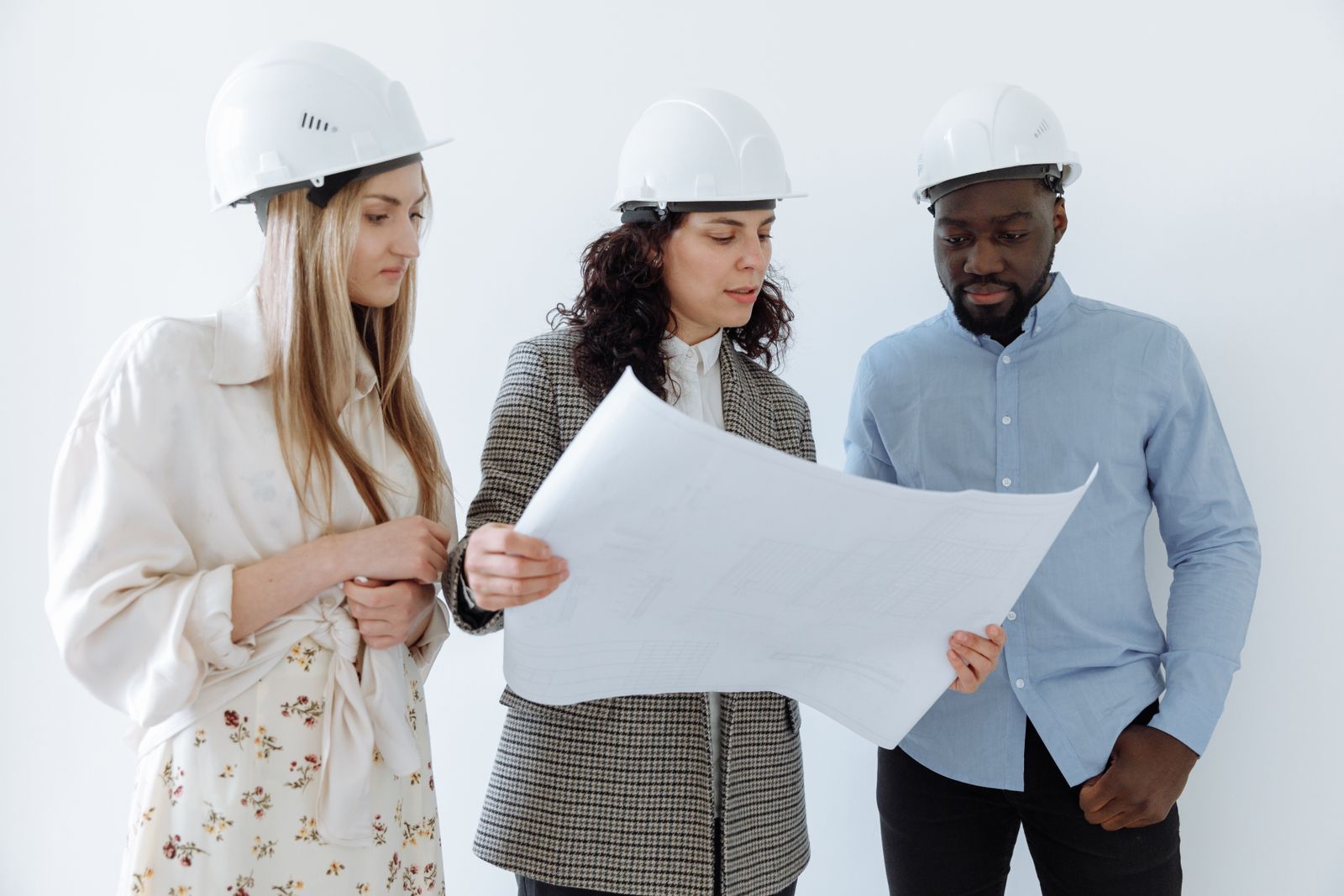 Diverse construction team reviewing project plans together